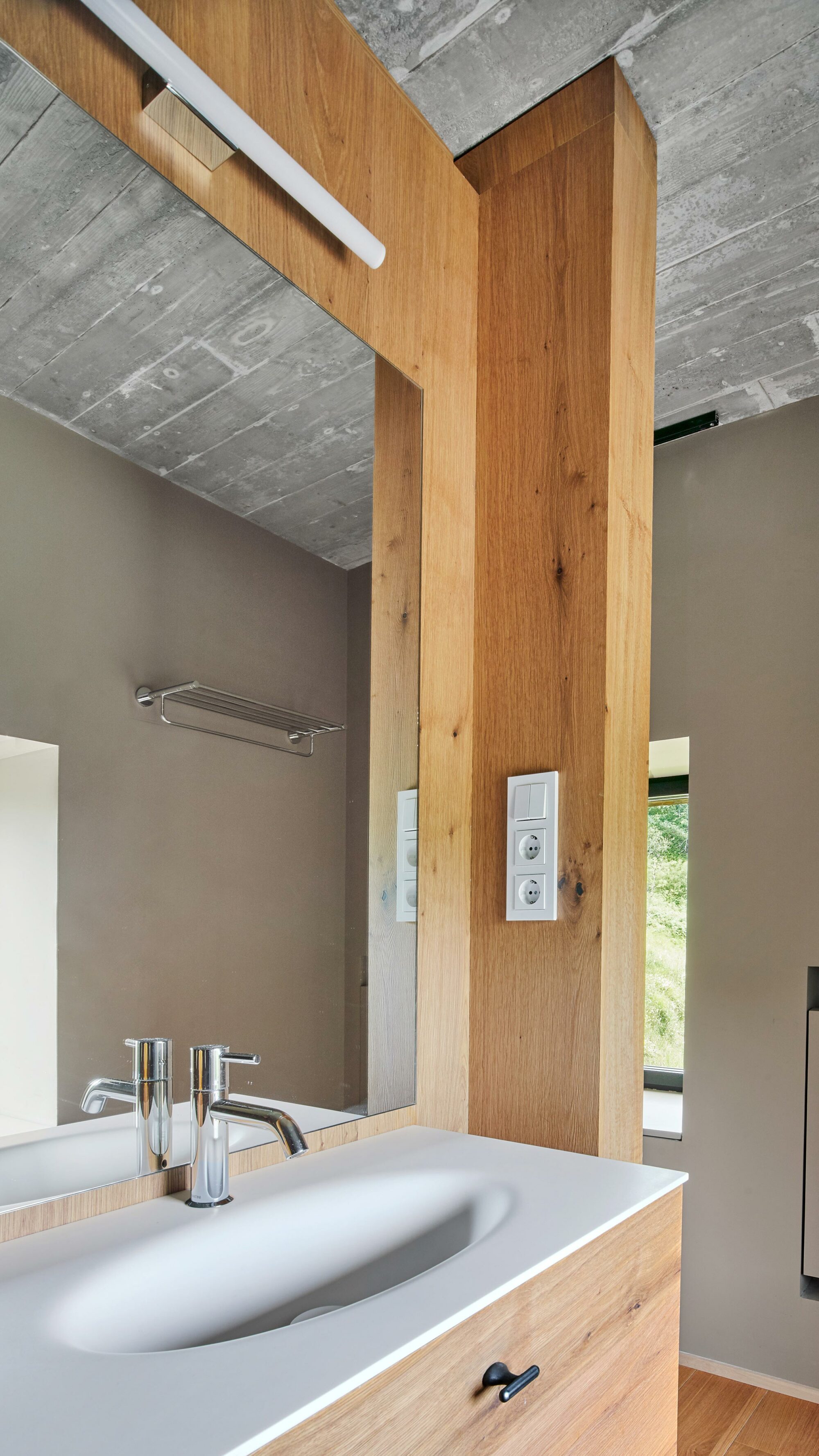 Parklex Prodema wate-resistant wood cladding, cut-to-size to fit electric and water outlets at the bathroom in Landaburu Borda country house