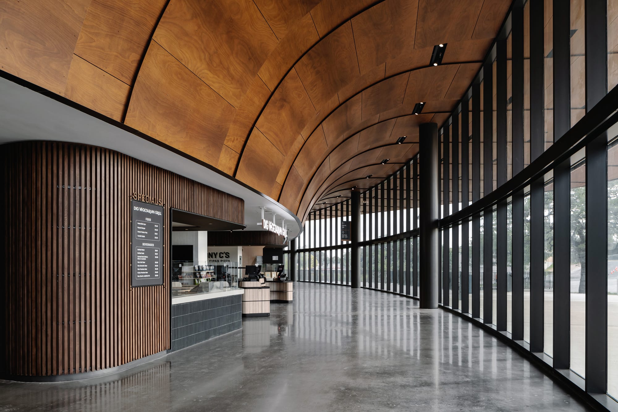 Parklex Prodema soffit has been custom-installed in situ and features natural Okume wood.