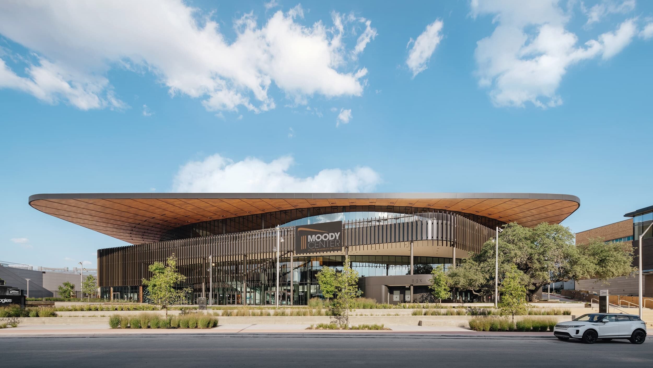 Parklex Prodema custom-installed natural timber soffit for a maintenance-free canopy at the University of Texas Moody Center Arena by GENSLER.