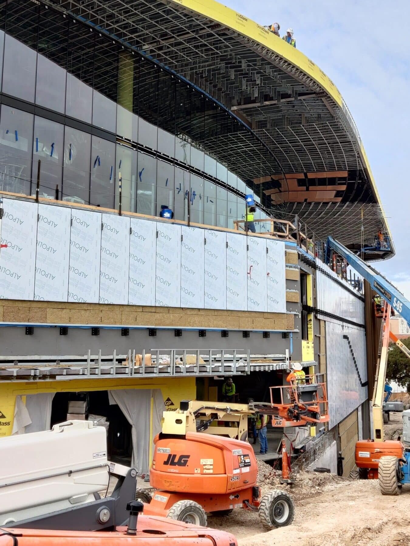 Process of custom installation of Parklex Prodema natural wood panels on the exterior of the canopy.