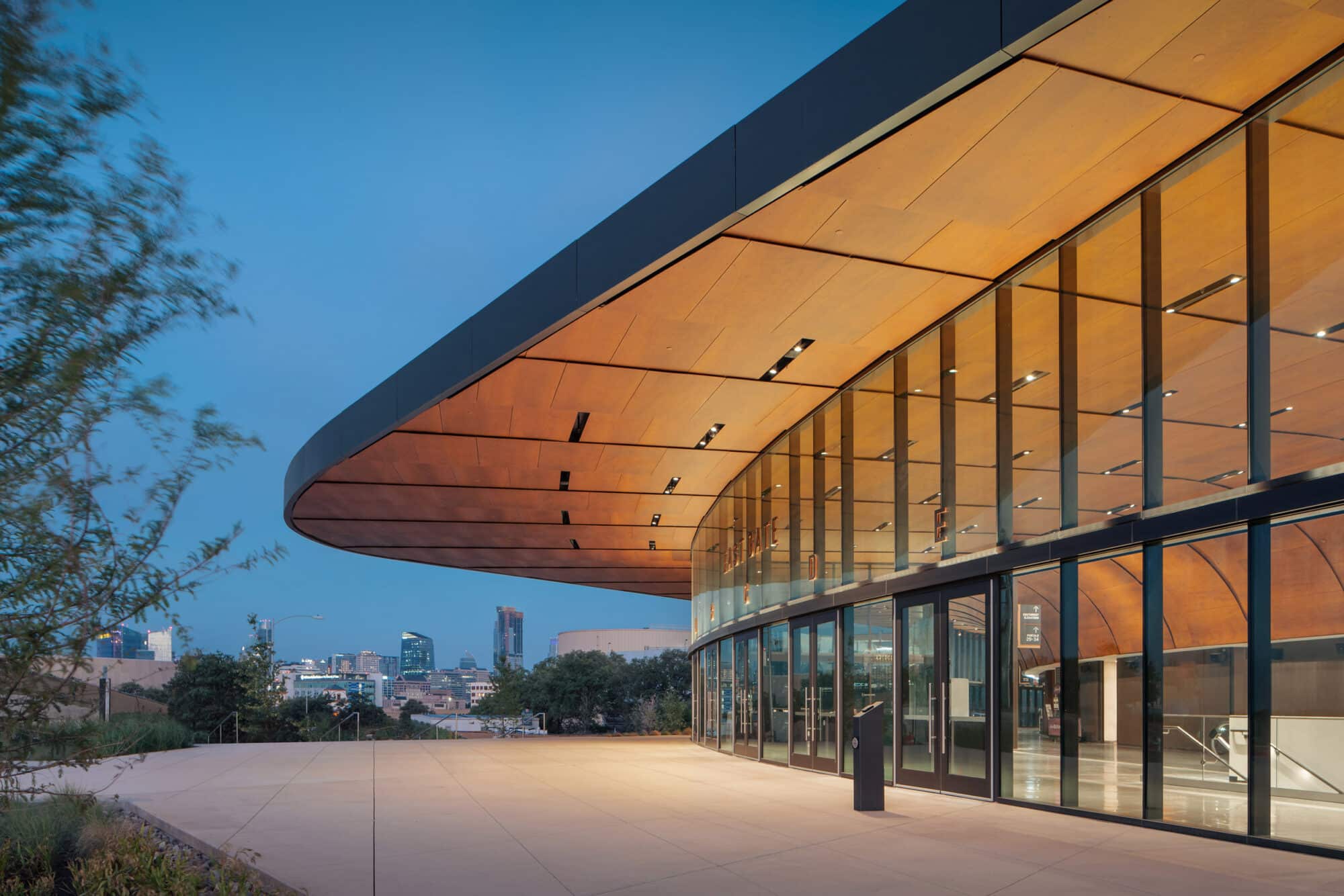 Natural wood panelling interior and exterior at Moody Center University of Texas Austin