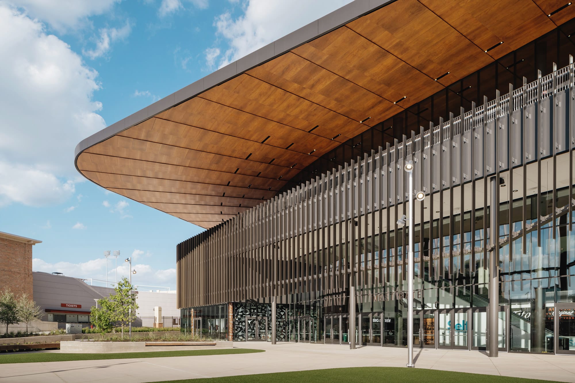 Natural wood curved soffit at Moody Center University of Texas Austin
